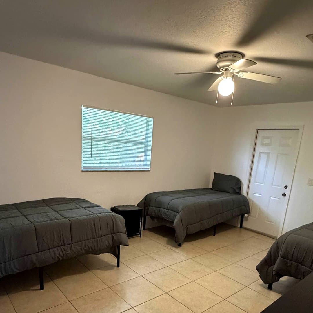 Spacious furnished bedroom at Dania Haven II men's sober living home in Dania Beach